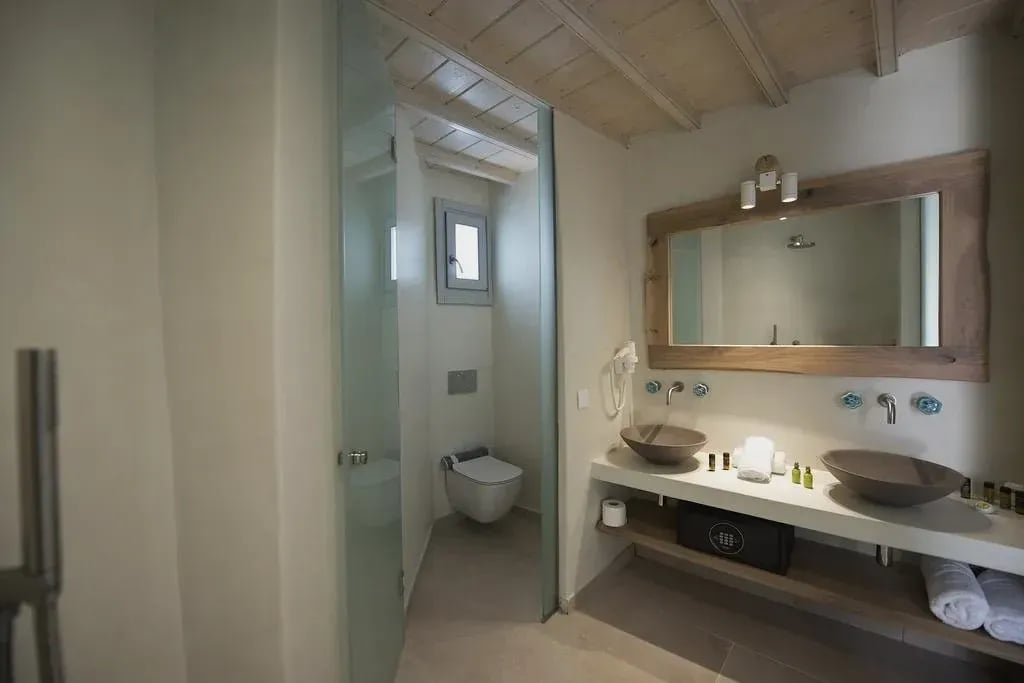 Bathroom with two stone basins and walk-in shower