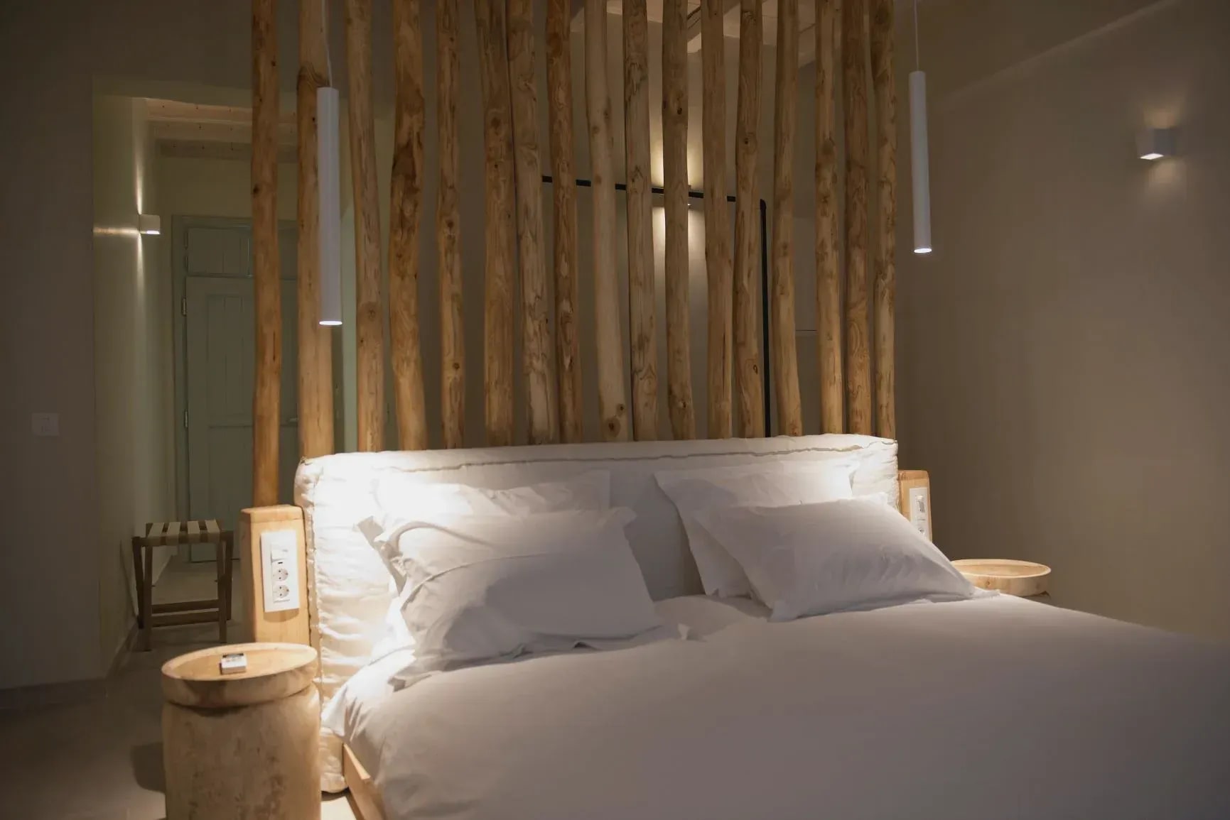 Bedroom with driftwood screen and woven pendant lighting