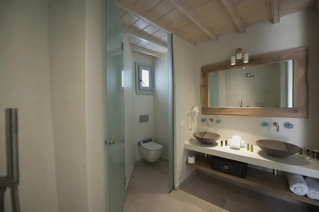 Bathroom with two stone basins and walk-in shower