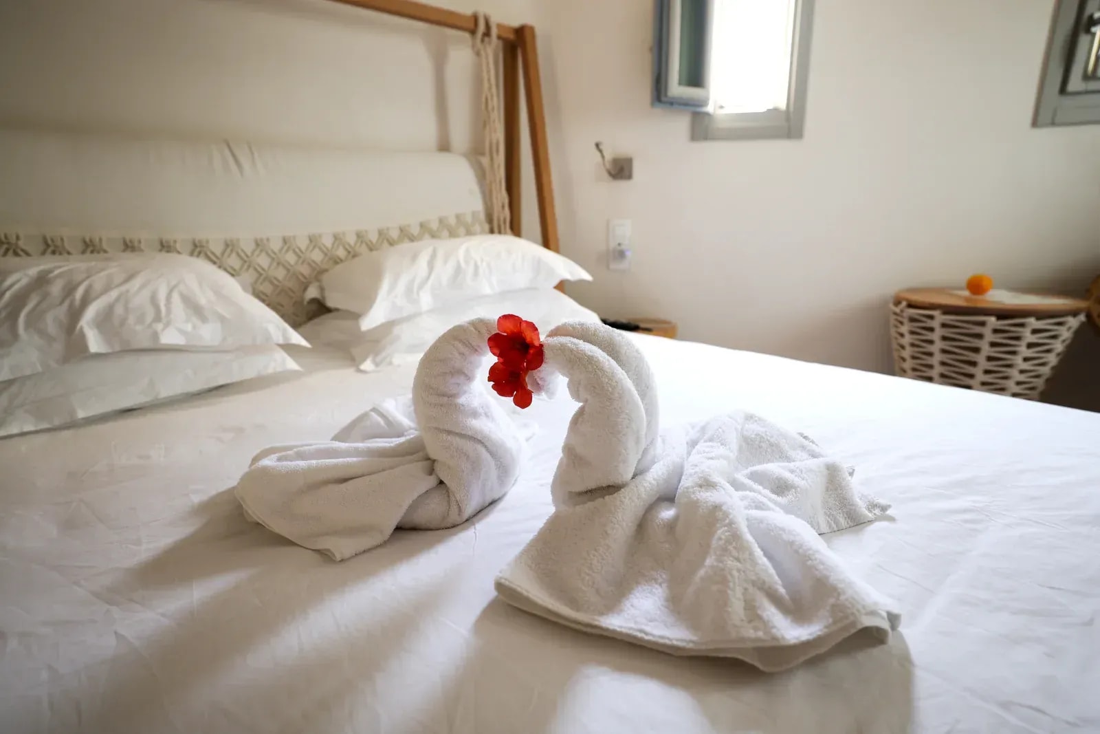 Folded towels and ceramic vessels arranged in a lit wall niche