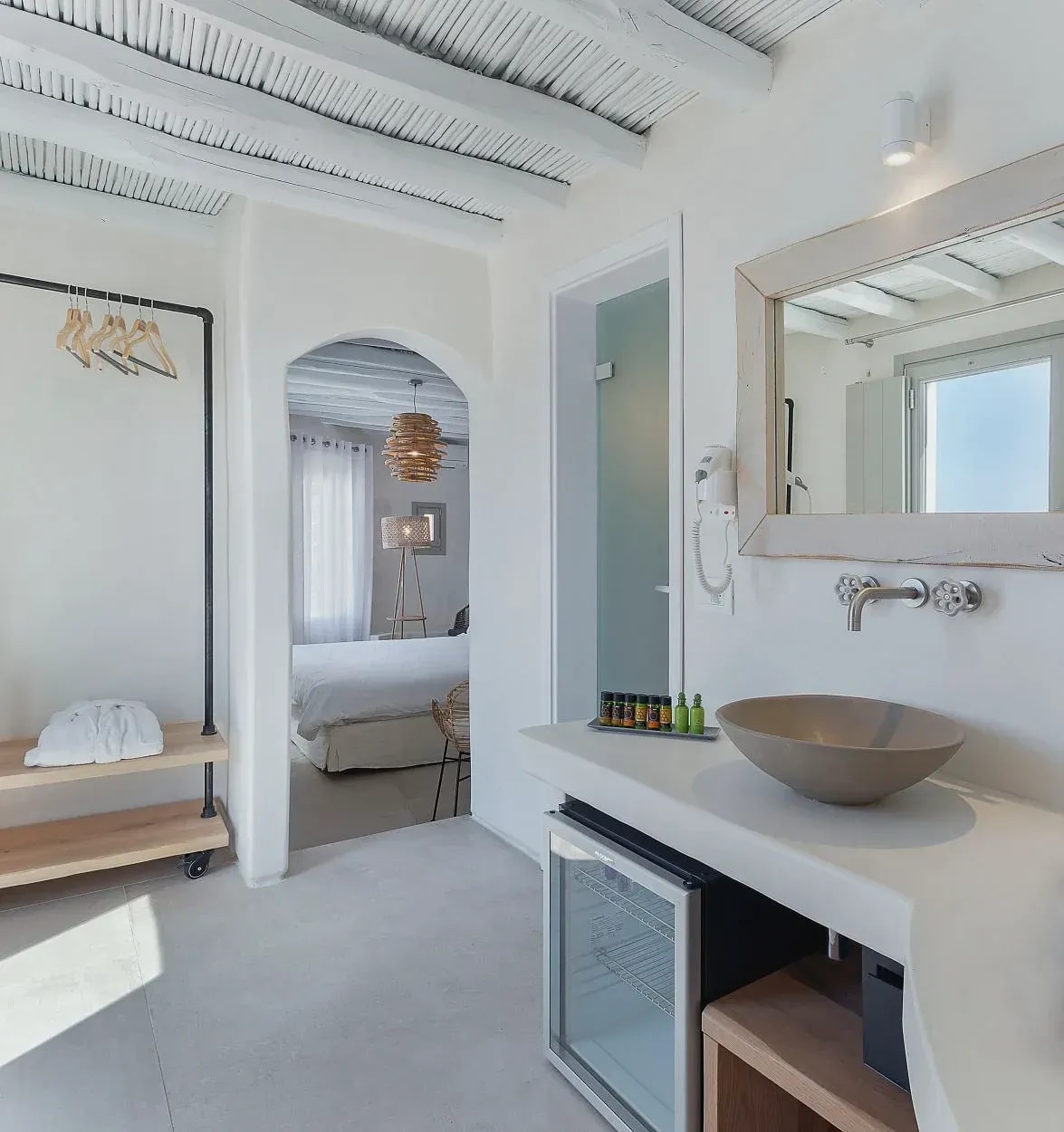 Bathroom vanity with stone basin, hanging rail and minibar