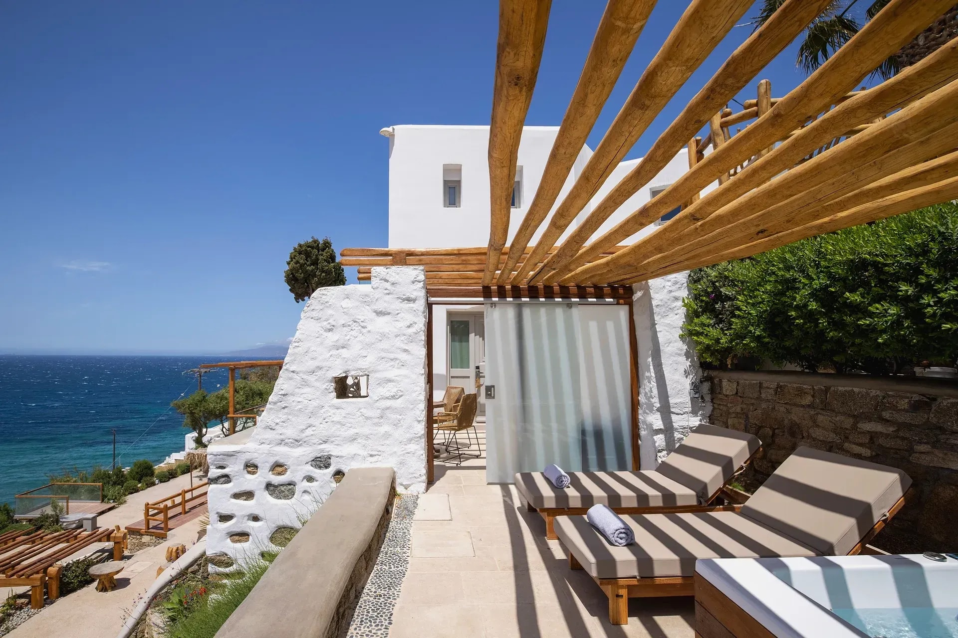 Sun loungers under the pergola on the suite terrace, open sea beyond
