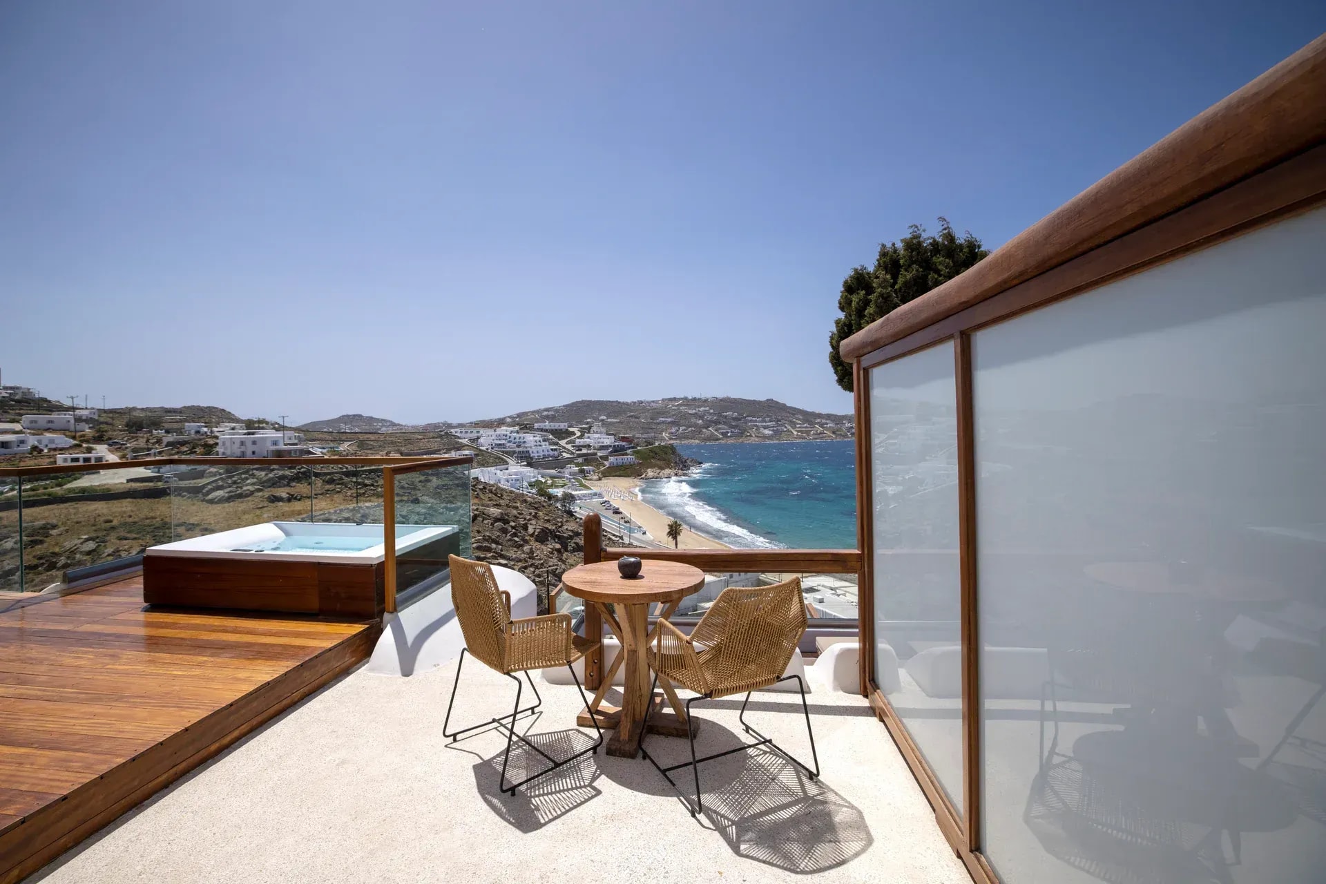 Terrace railing above the bay, looking across to the beach and the hills